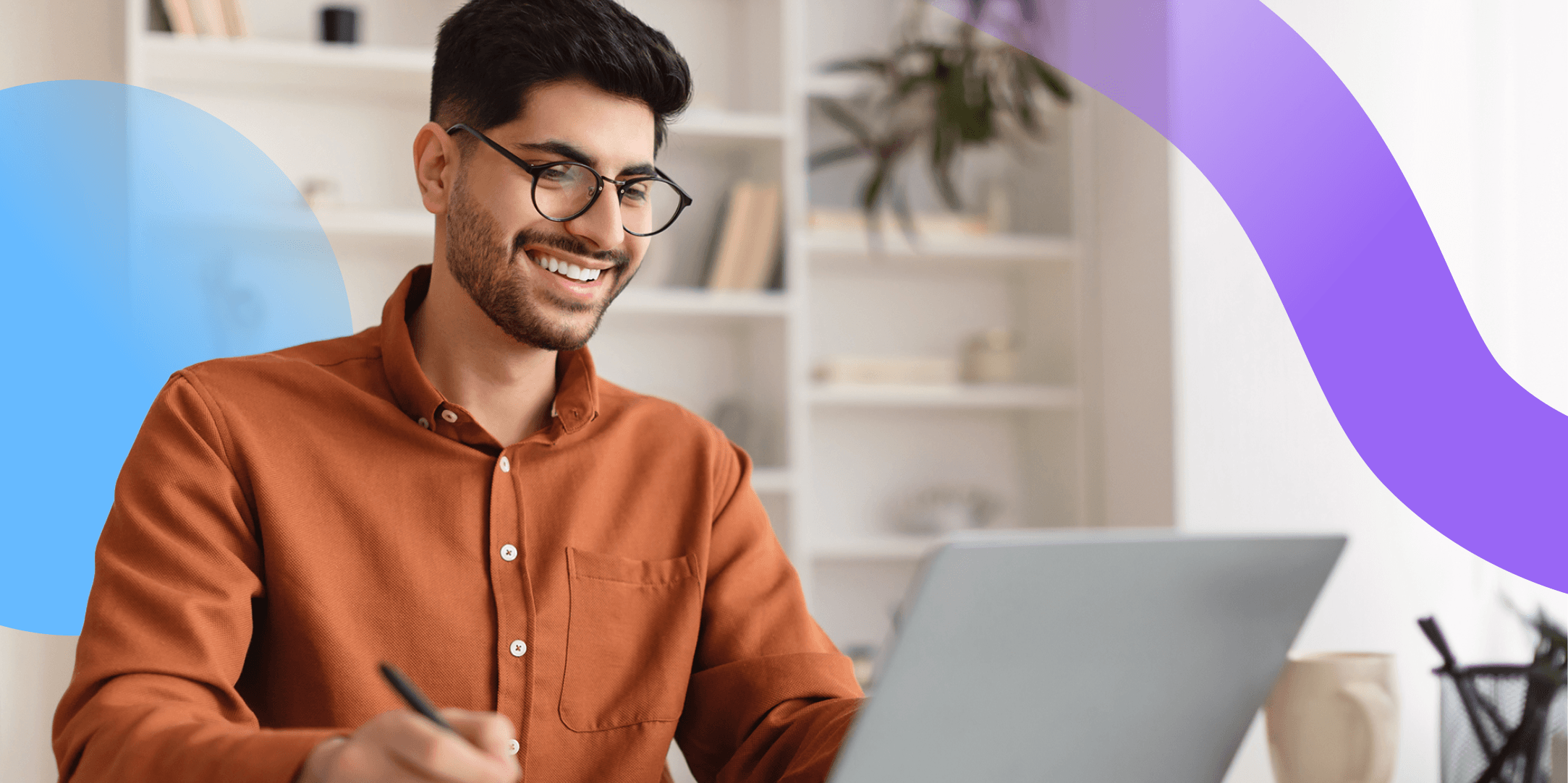 A professional man is sitting at a laptop launching a new digital workplace tool.